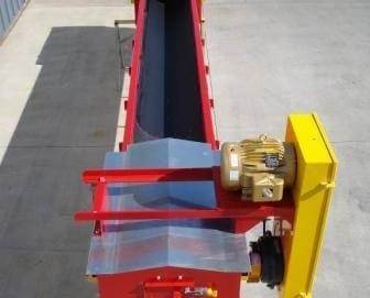 A round bottom conveyor sits outside of a manufacturing facility.