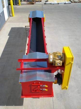 A round bottom conveyor sits outside of a manufacturing facility.